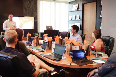 meeting office employees with laptops