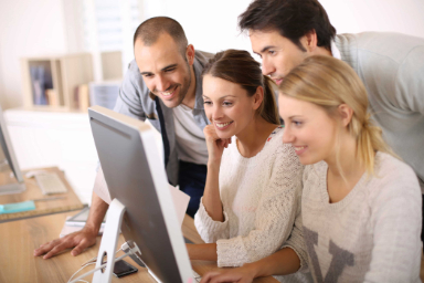 people in front of computer in office elearning