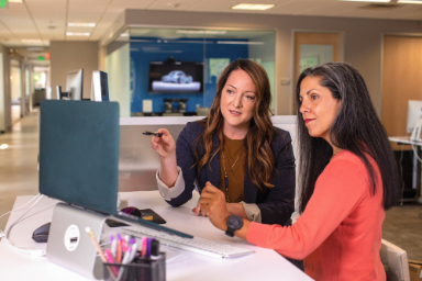 women in office working in front computer